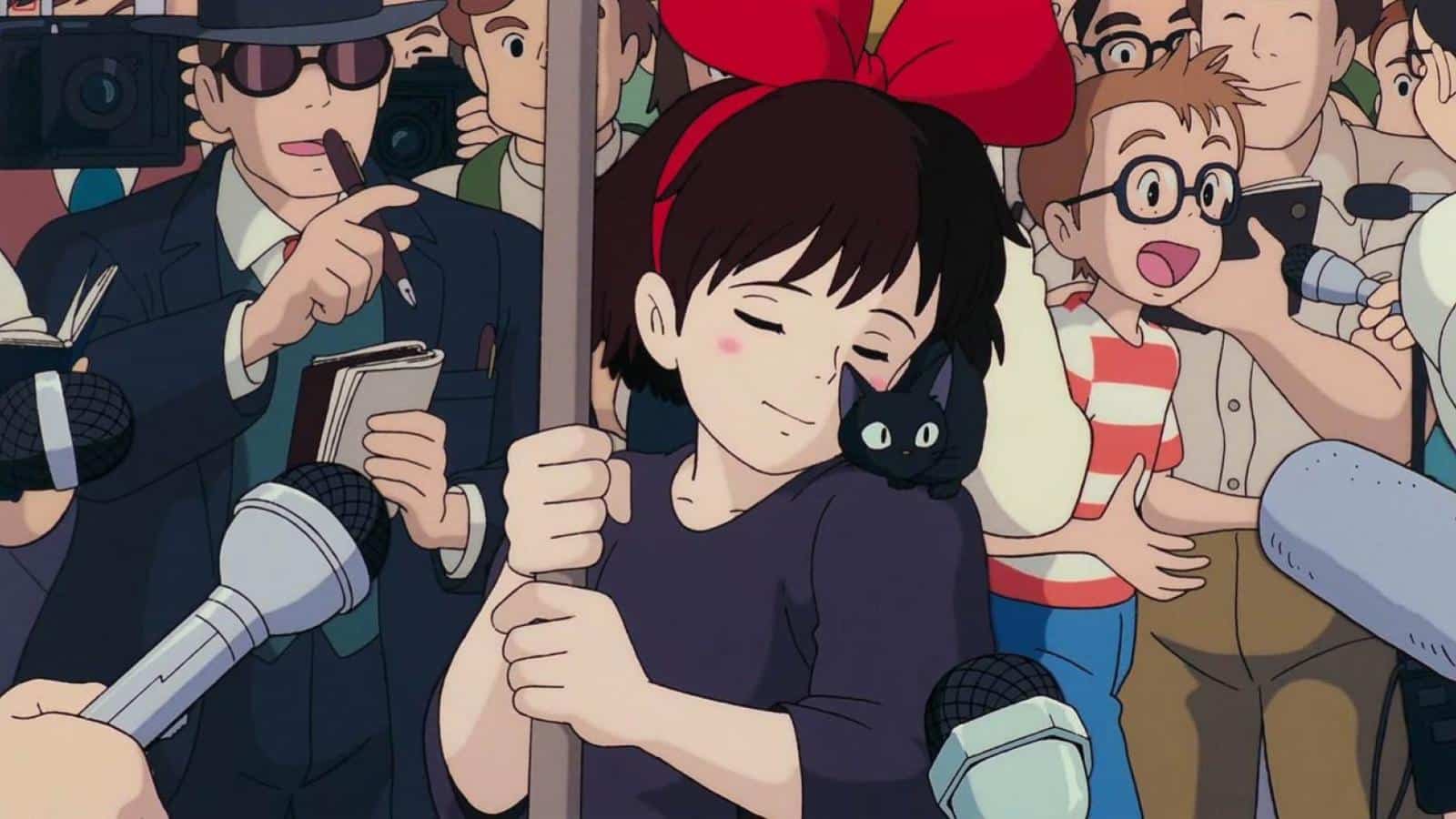 Kiki entourée de journalistes avec son chat Jiji dans ce film Ghibli