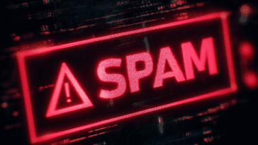 Alerte SPAM sur un écran d’ordinateur avec triangle rouge et point d’exclamation – visuel fort pour illustrer les risques liés aux spams.