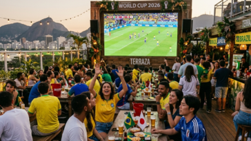 Foule joyeuse dans un bar en terrasse regardant un match de la Coupe du Monde 2026 entre le Brésil et le Japon