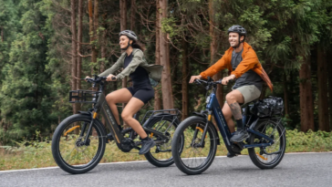 Deux cyclistes roulant sur le vélo électrique ENGWE E26 3.0 Pro le long d'une forêt.